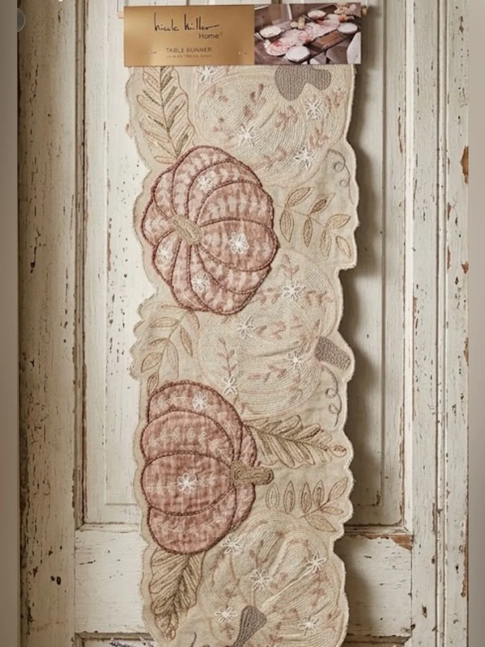 Nicole Miller Home beaded table runner featuring a festive fall pumpkin and leaf